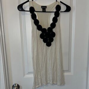 Women’s cream razor back tank top with black floral accents